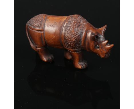 A carved hardwood Chinese netsuke. A Rhinosaurus. 3.5cm height.  