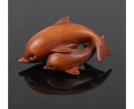 A carved hardwood Chinese netsuke. A Dolphin &amp; calf. 7cm length.  