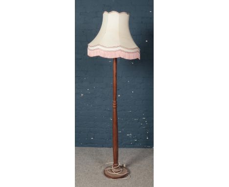 A turned mahogany standard lamp with shade.  