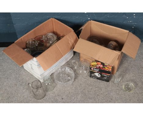Two boxes of mostly glassware. To include measuring jugs, vases and lemon squeezer etc.  