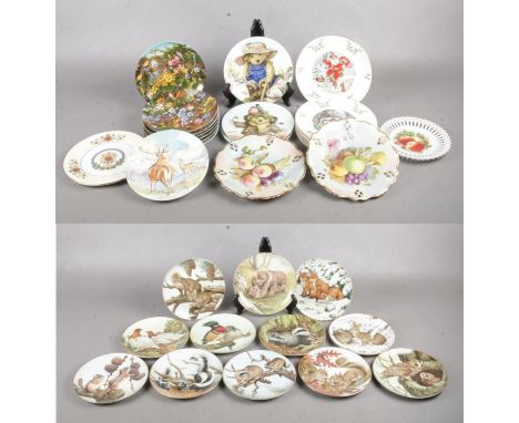 A box of collectors plates. 'The Forest Year' by John Francis. To include Rabbits in the Snow (1983), Owls in the August Twil