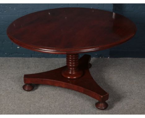 A Victorian mahogany tilt top dining table. With turned centre column support and tripod base. Diameter 124cm.  