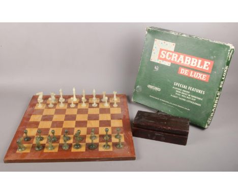 A Chess set together with a Deluxe Scrabble set. Comprising of Jade coloured pieces (32) in box. Chess board 47x47cm.  
