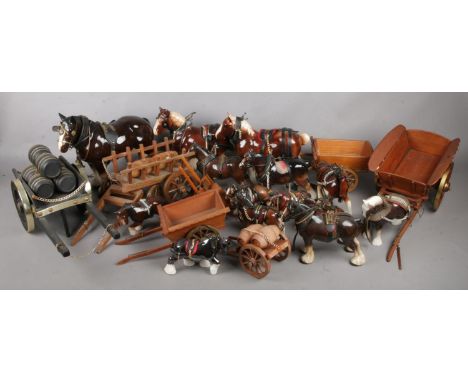 A large collection of ceramic shire horses and wooden carts.  
