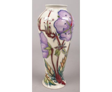 A Moorcroft ceramic vase decorated with purple flowers. 20.5cm.  