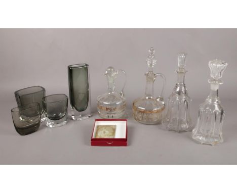 A selection of assorted glassware. To include a Swedish Orrefors vase no 3595/2, four glass decanters and a glass photographi