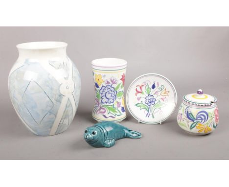 Five pieces of assorted Poole Pottery. To Include a 'Bellini' hand-painted vase, a ceramic seal and three pieces of floral de