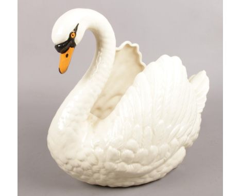 A large Dartmouth pottery swan planter. 29cm tall.  Chip to tail.