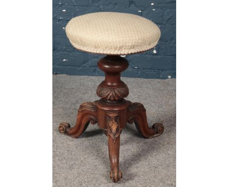 A Victorian carved mahogany tripod piano stool.  