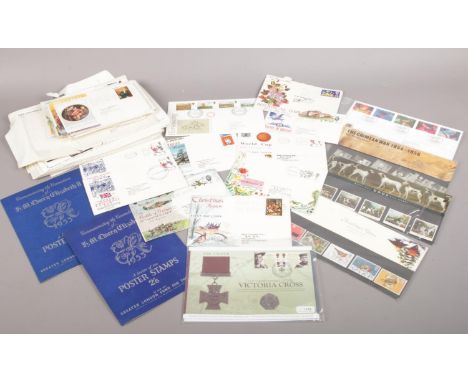 A collection of British &amp; World stamps/first day covers. To include a commemorative Victoria cross coin and stamp set.  