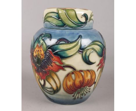 A Moorcroft ceramic ginger jar. Decorated in the Anna Lilly design. 15cm.  Good condition.