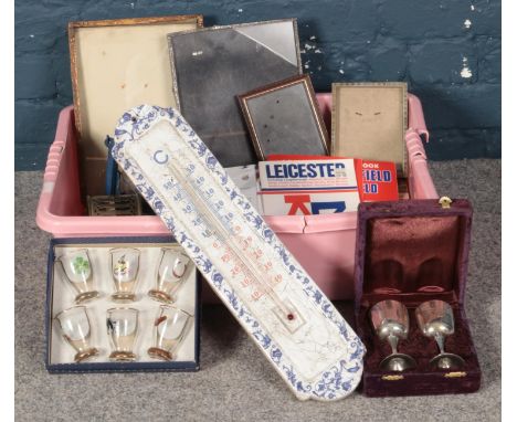 A Box of Miscellaneous Items. To include a Large Garden Thermometer, a set of Six Shot Glasses and a Series of Photo Frames. 