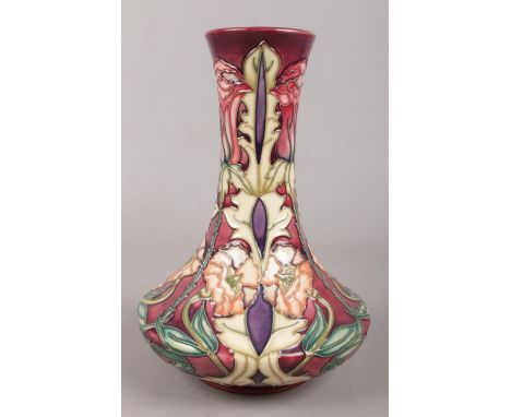 A Moorcroft ceramic vase, decorated in the Masquerade design. 21cm.  Good condition.