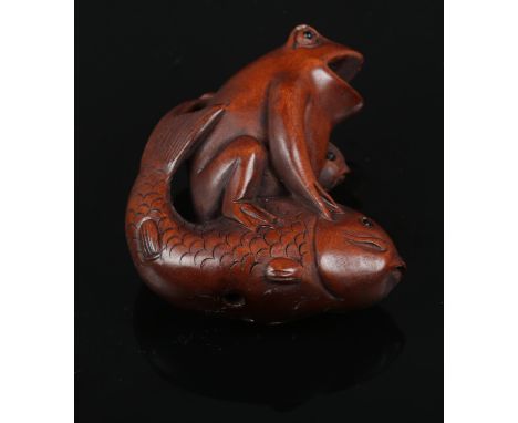A carved hardwood Chinese Netsuke. Frog sat on a fish. 4.5cm height.  