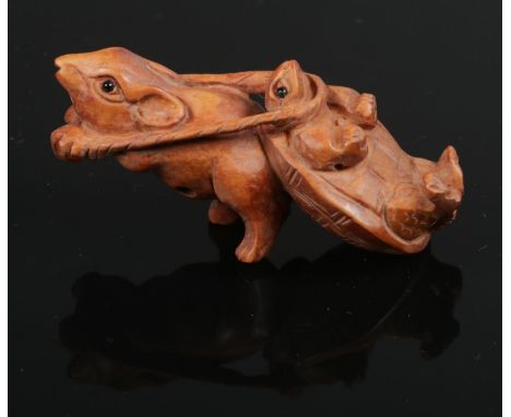 A carved hardwood Chinese netsuke. Rat pulling a turtle. 6.5cm length.  