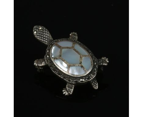 A silver tortoise brooch with mother of pearl inlay. 3.5 cm length.  