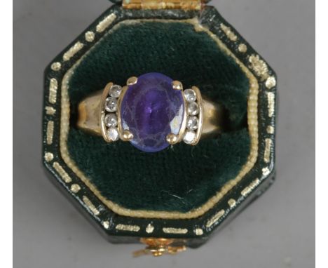 A gold tanzanite ring set with diamond shoulders. Size K. 5.17g.  