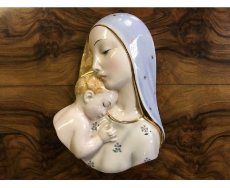 An Italian ceramic wall plaque of Madonna and child.