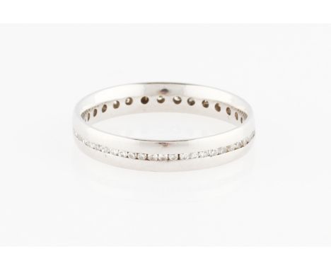 A platinum diamond full eternity ring, channel set with round brilliant cut diamond accents, hallmarked Sheffield, ring size 