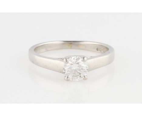 A platinum diamond solitaire ring, set with a round brilliant cut diamond measuring approx. 0.50ct, with raised shoulders, ha