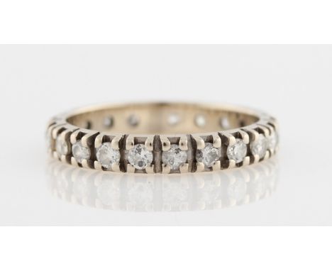 A diamond full eternity ring, set with 21 diamonds, some round brilliant cut and some old cut, average diamond size approx. 0