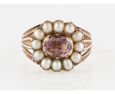 A 19th Century rose quartz and pearl ring, set centrally with an oval rose quartz, surrounded by a border of pearls, set in u