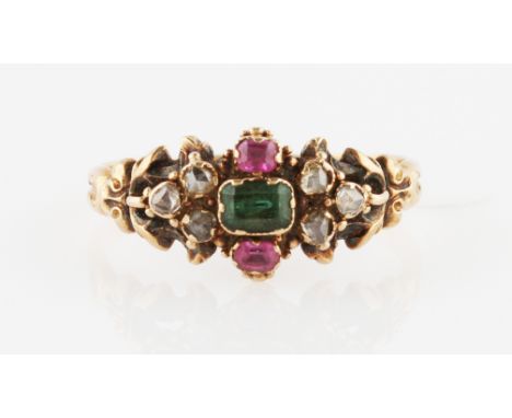 A Victorian emerald, ruby and diamond ring, set centrally with an emerald cut emerald, flanked to either side with a square c