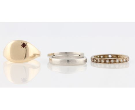 A lot to include two wedding bands, both stamped PLAT, a gents signet ring, unmarked yellow metal and a full eternity ring, (