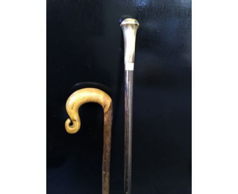 A bone handled walking cane with 9ct gold band, together with a crook walking stick.