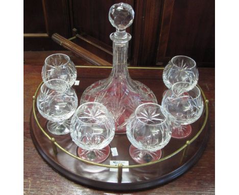 Cut lead crystal glass decanter set to include Ship's-type decanter and six matching brandy balloons on a wooden, galleried t