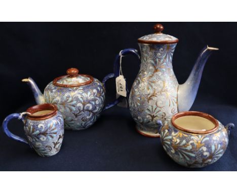 Doulton Lambeth four-piece tea service having blue, white and gilded stylized foliate decoration, to include: teapot, coffee 