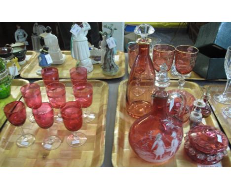 Two trays of cranberry glass items to include: set of eight wine glasses, mallet shaped decanter and stopper with matching gl