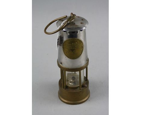 A MINERS LAMP, manufactured by The Protector Lamp & Lighting Co. Ltd, Eccles Manchester, Type MG40, appears largely complete,