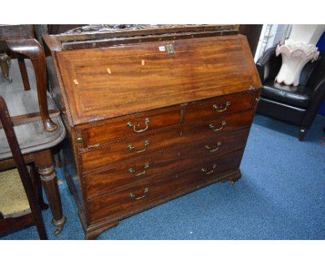 A GEORGIAN MAHOGANY AND INLAID WRITING BUREAU, with fall front, fitted interior, two short and three long drawers with brass 