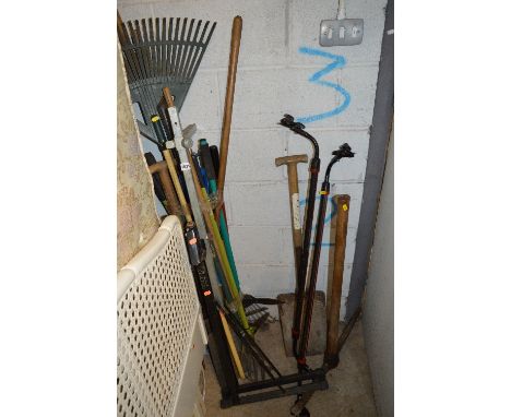 A QUANTITY OF GARDEN TOOLS, including pick axe, roof rack, spades, etc