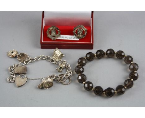 A SILVER CHARM BRACELET, a set of silver Manchester United cufflinks and a smokey quartz gold set bracelet (3)