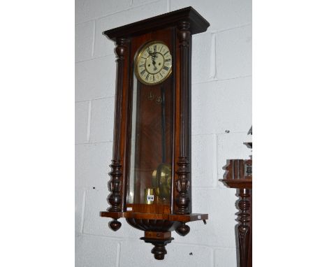A WALNUT VIENNA WALL CLOCK, with enamel dial and Roman numerals (losses) (pendulum, two weights and winding key)