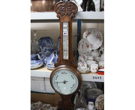 AN EARLY 20TH CENTURY OAK CASED ANEROID BAROMETER, THERMOMETER SCALE (a.f) together with a vintage enamel bread bin and simil