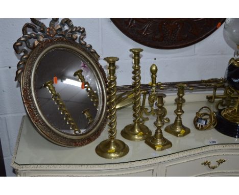 A QUANTITY OF BRASSWARE, to include a fender, set of three fire irons with two dogs, fire screen and two pairs of candlestick