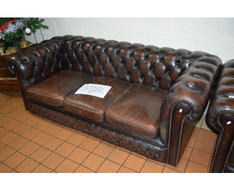 A CHOCOLATE LEATHER THREE SEATER CHESTERFIELD SOFA, approximate width 200cm