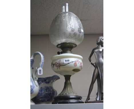 A LATE VICTORIAN OIL LAMP, acid etched shade, cream glass reservoir enamelled in pink orchids, on a brass base, height to top