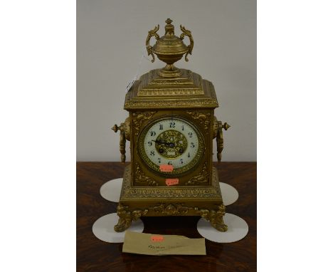 A 20TH CENTURY GILT METAL BRACKET CLOCK, enamel circular face, Arabic numerals, in ornate case with urn finial, on scrolled f