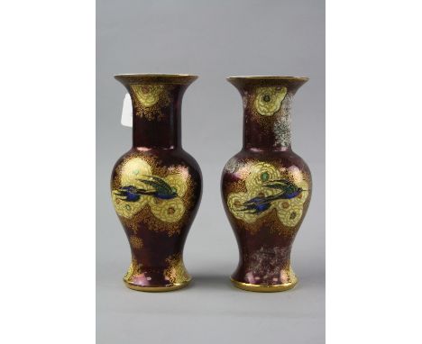 A PAIR OF CARLTON WARE VASES, with painted and gilt exotic bird decoration on a red and mottled ground, printed back stamp, i
