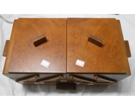 A vintage wooden sewing box containing a quantity of sewing items including threads, pins, needles, etc.