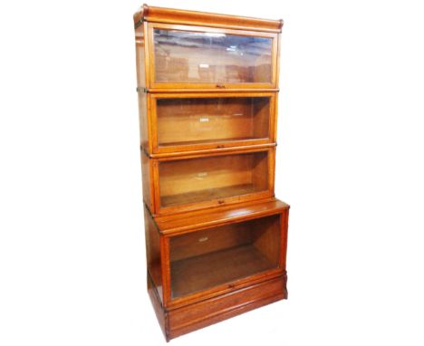 An 86cm early 20th Century Globe Wernicke light oak four section modular bookcase with cornice and plinth base - some section