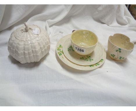 A Belleek porcelain trio of typical form, with moulded basketweave and shamrock decoration with hand painted finish - sold wi