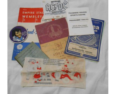 A small bag of ephemera including AC/DC concert ticket, football programmes and an Elvis cloth badge