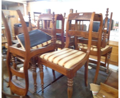 A set of eight 19th Century mahogany and strung ladder back dining chairs with upholstered drop-in seats, set on turned front