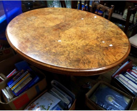 A 1.34m Victorian figured walnut veneered ovel tilt-top loo table, set on an ornate open base with central finial and quadrup