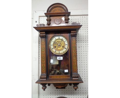 A late 19th Century simulated inlaid walnut cased wall clock with decorative dial and spring driven gong striking movement